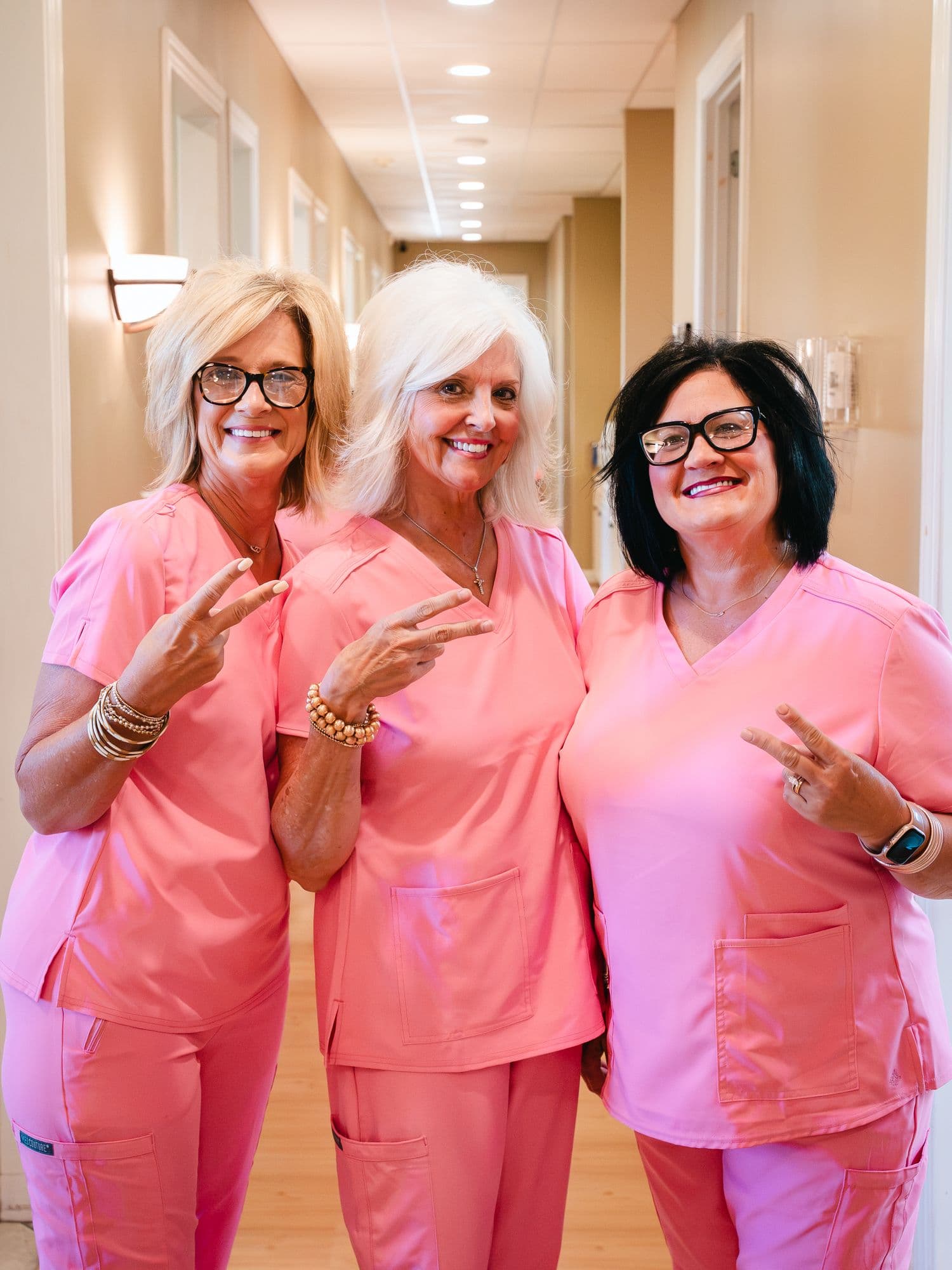 Three members of the Park Place Dental team sharing a laugh in the hallway
