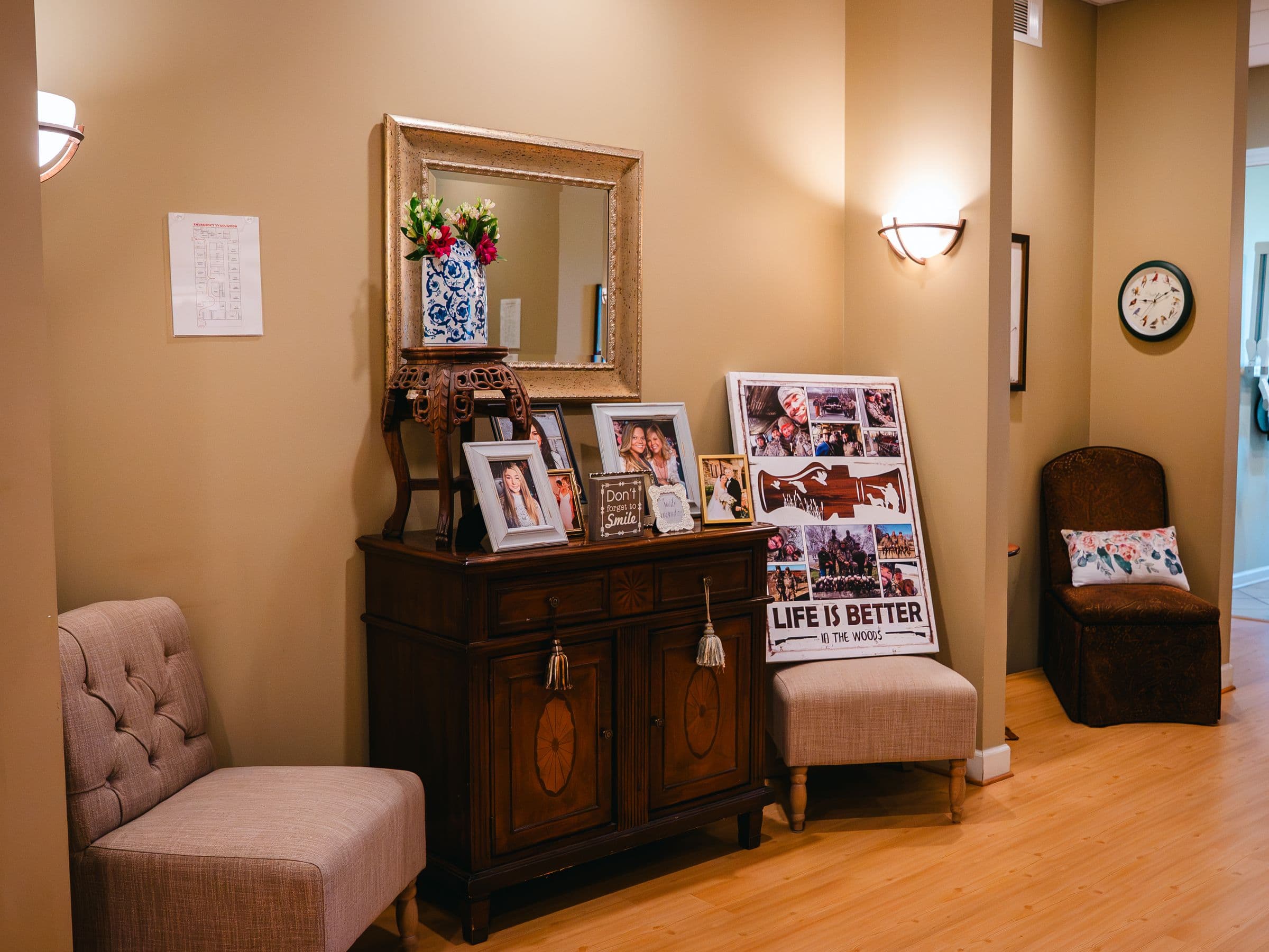 A corner of the waiting area at Park Place Dental, with a wall of framed family photographs